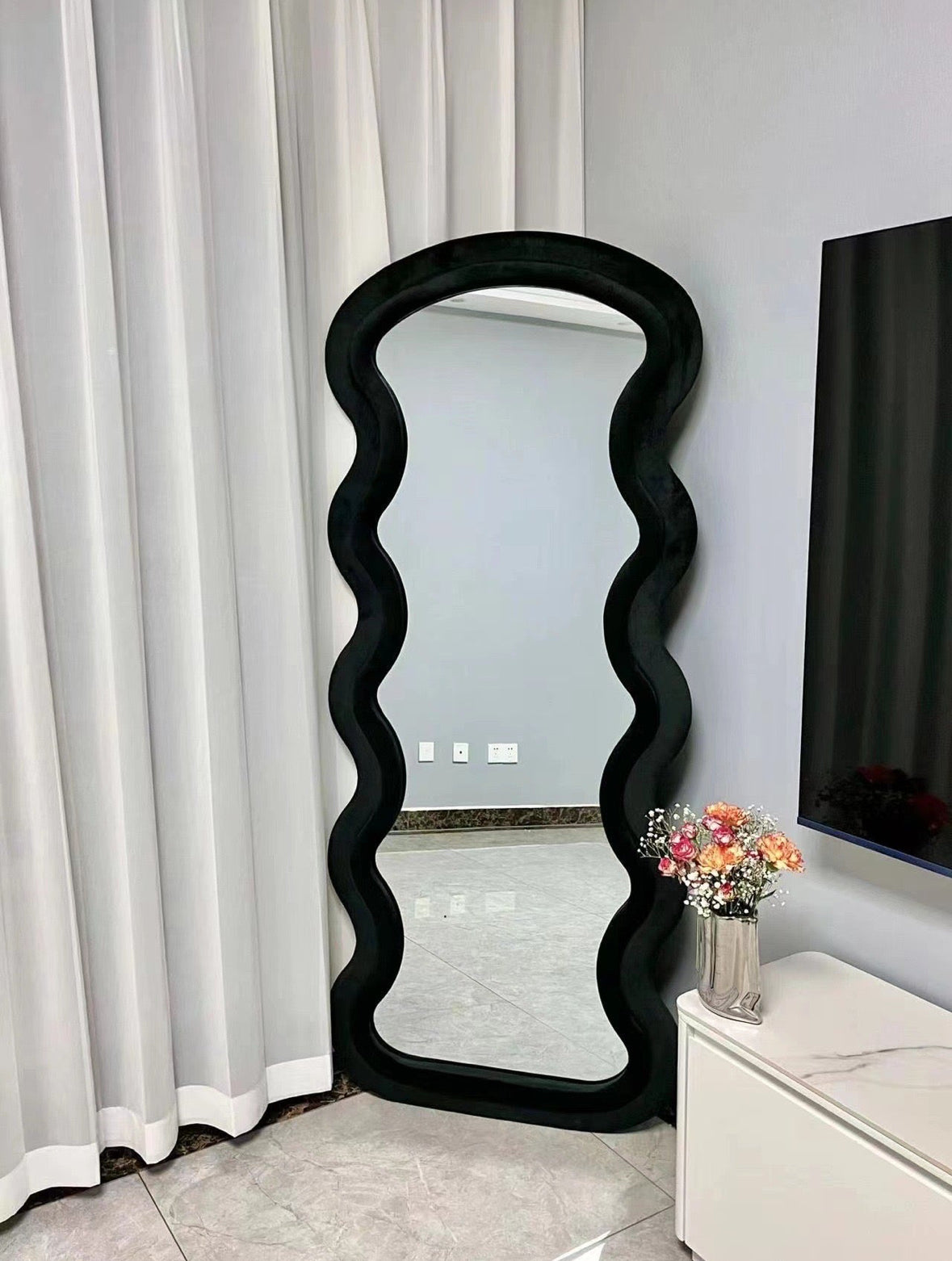 Wavy black velvet wall mirror